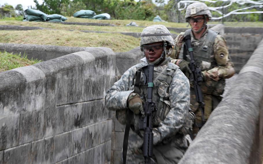 Soldiers from the 10th Regional Support Group shuffle out of fortified trenches during a live-fire exercise on Okinawa, Wednesday, March 21, 2018.