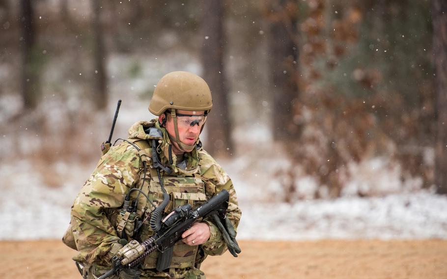Snow falls as a soldier with the Army's 1st Security Force Assistance Brigade moves toward a mission objective during training Jan. 16 at the Joint Readiness Training Center at Fort Polk in Louisiana. 
