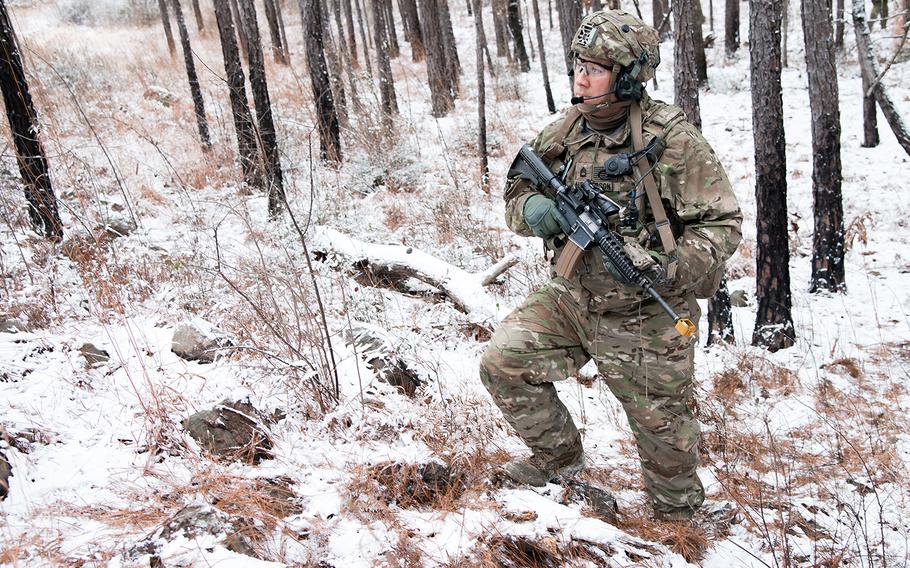 A soldier with the Army's 1st Security Force Assistance Brigade pauses during a patrol on a rare snowy day at the Joint Readiness Training Center at Fort Polk, La. as part of a training rotation Jan. 16.