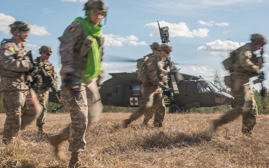 Soldiers with the Army's 1st Security Force Assistance Brigade and others portraying Afghan soldiers move away from an HH-60 Black Hawk medical evacuation helicopter on Jan. 15 after loading casualties. The scenario was part of a mission rehearsal exercise for the 1st SFAB, which was preparing for its spring deployment to Afghanistan.