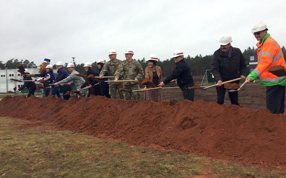 U.S. military, school and German construction officials shovel a pile of dirt on March 28, 2018, to symbolically mark the start of construction on a new Ramstein High School near Kaiserslautern, Germany. The school is scheduled to be ready for students and teachers by fall of 2021.