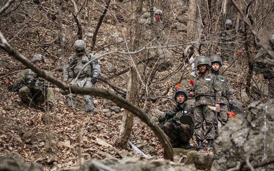 U.S. and South Korean forces investigate a site containing suspected unexploded ordnance at Pocheon, South Korea, Thursday, March 29, 2018.