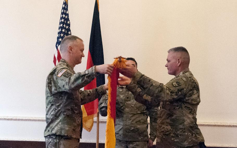 Col. Richard Wholey, commander of the 678th Air Defense Artillery Brigade, left, and Command Sgt. Maj. Anthony Collins uncase the unit's colors during a ceremony at Bismark Kaserne in Ansbach, Germany, Tuesday, March 27, 2018.