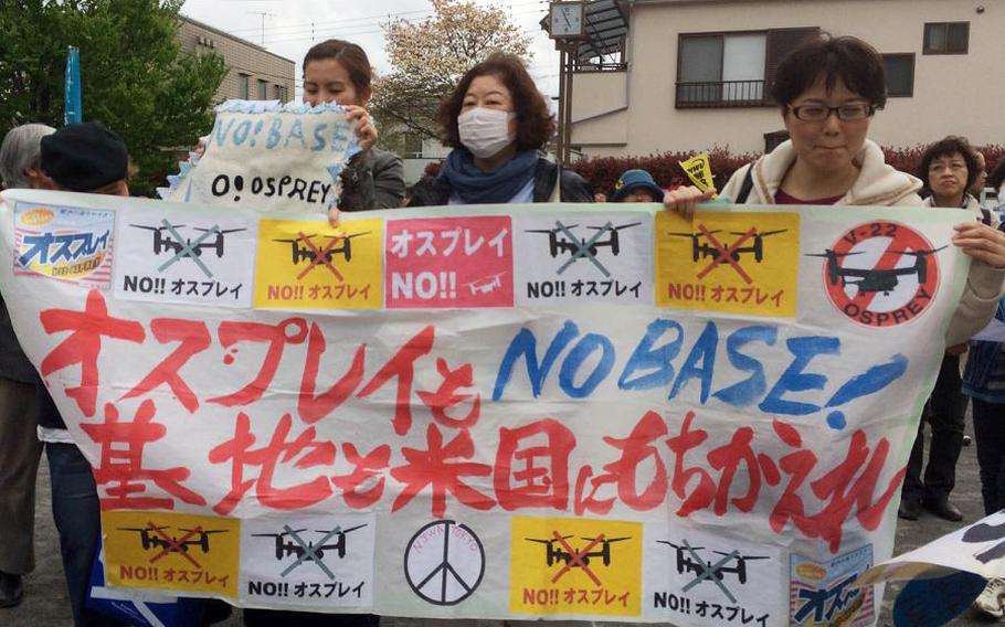 Japanese residents protest the presence of Air Force CV-22 Ospreys at Yokota Air Base, Japan, Friday, April 6, 2018.