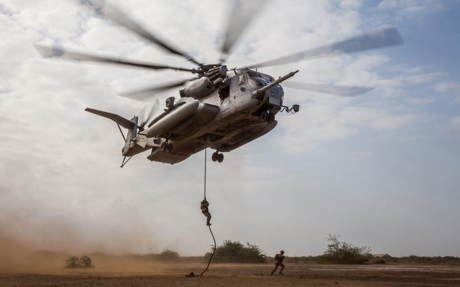 U.S. Marines fast-rope from a CH-53E Super Stallion during helicopter rope suspension technique training near Camp Lemonnier, Djibouti, Feb. 7, 2017. U.S. air operations in Djibouti remain grounded Friday after two Marine Corps aircraft  were involved in crashes earlier this week.