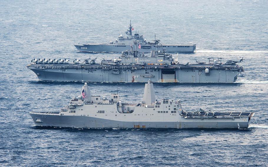 The USS Green Bay, front, the USS Wasp, center, and the JS Shimokita sail in formation in the East China Sea, Monday, April 9, 2018.