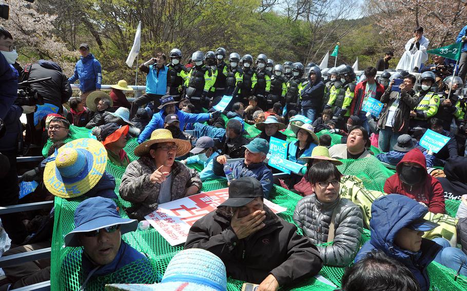 South Korean police fan out as residents protest equipment being moved to the site of an advanced U.S. missile defense system in the southeastern region of Seongju, Thursday, April 12, 2018.