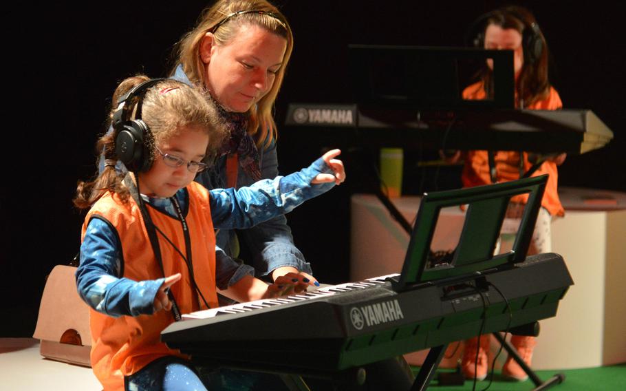 A young visitor to the Musikmesse in Frankfurt, Germany tries her hand at a keyboard Wednesday, April 11, 2018. In Hall 10 there is a section called ''Discovering Music,'' where youngsters can try a variety of instruments.
