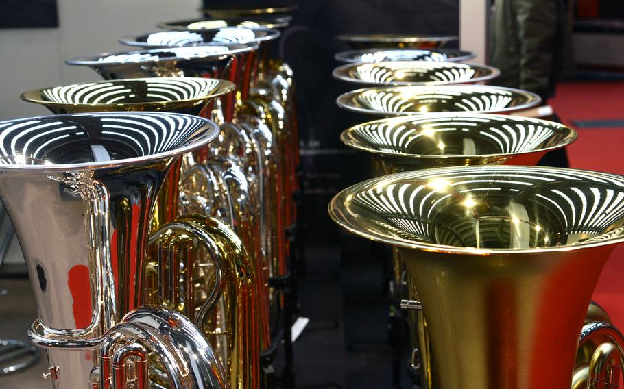 The lights of the exhibition hall are reflected in the bells of tubas on display at the Musikmesse in Frankfurt, Germany, Wednesday, April 11, 2018.
