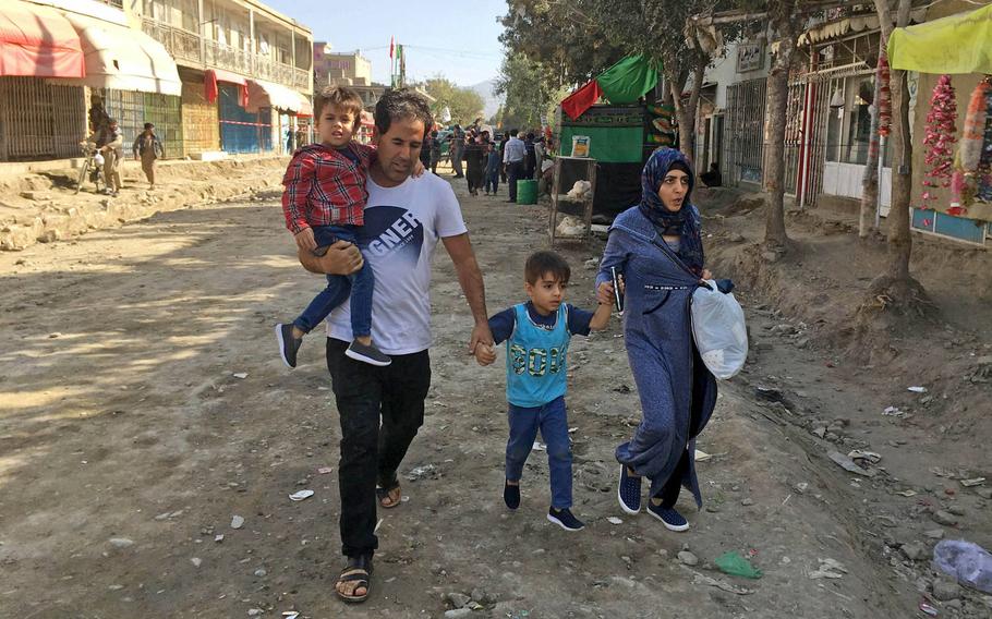 A family evacuates the area around the Shiite Hussainia Mosque in Kabul after a suicide attack. Civilian casualties in Afghanistan remained near record levels during the first three months of the year, according to the United Nations mission in the country, which released data on Thursday.