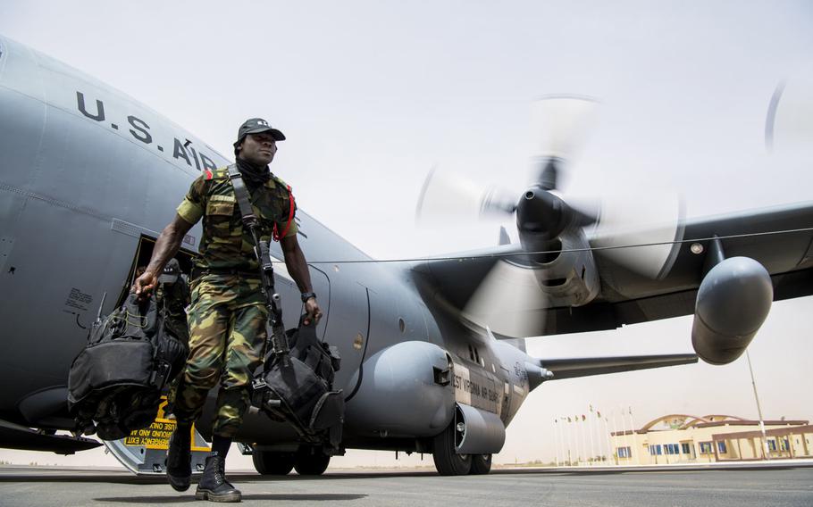 A Burkina Faso soldier exits a U.S. Air Force C-130H Hercules at Diori Hamani International Airport, Niger, April 10, 2018. Approximately 1,900 servicemembers from more than 20 African and western partner nations are participating in Flintlock 2018 at multiple locations in Niger, Burkina Faso and Senegal.
