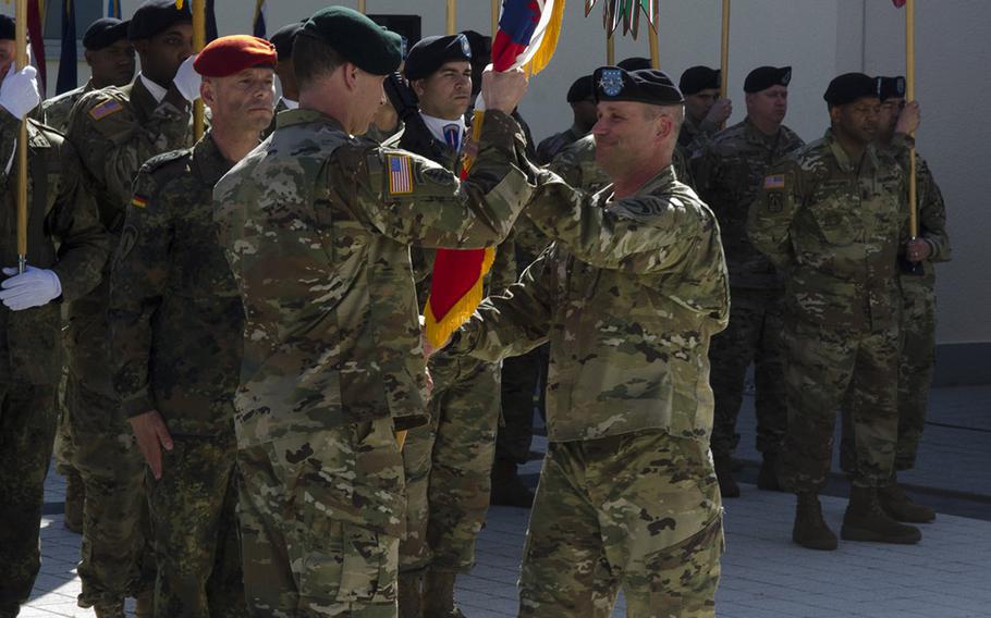 Command Sgt. Maj. Robert Abernethy, new U.S. Army Europe senior enlisted leader, accepts the USAREUR colors from Lt. Gen. Christopher Cavoli, USAREUR commander, during his assumption of responsibility ceremony Thursday, April 19, 2018, at Clay Kaserne in Wiesbaden, Germany. 