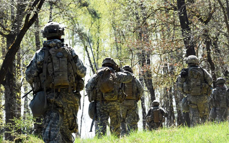Soldiers with the 1st Infantry Division's 2nd Armored Brigade Combat Team patrol through a German forest, during an exercise at Grafenwoehr, Germany, Thursday, April 19, 2018.