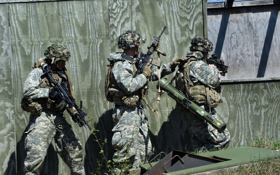 Soldiers with the 1st Infantry Division's 2nd Armored Brigade Combat Team clear buildings, house-to-house, during an exercise at Grafenwoehr, Germany, Thursday, April 19, 2018.