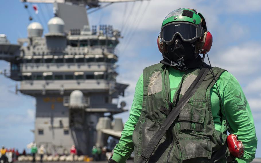 Petty Officer 3rd Class Yasmin Downs poses for a photo on the flight deck aboard the aircraft carrier USS Harry S. Truman in the Atlantic Ocean, Saturday, April 14, 2018. The Truman and its carrier strike group have since entered the European theater of operations.