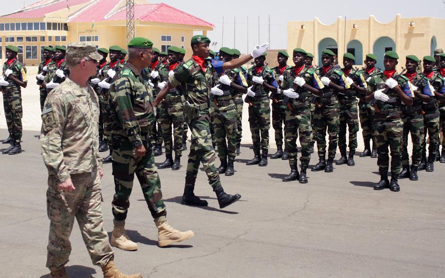 Maj. Gen. Marcus Hicks, leader of Special Operations Command Africa, left, reviews local troops in formation during a visit Thursday to Flintlock 2018 headquarters in Agadez, Niger. Flintlock, which ended Friday, is the largest U.S. special operations exercise in Africa and comes at a time when commanders are worried that extremist groups in the region are gaining momentum.