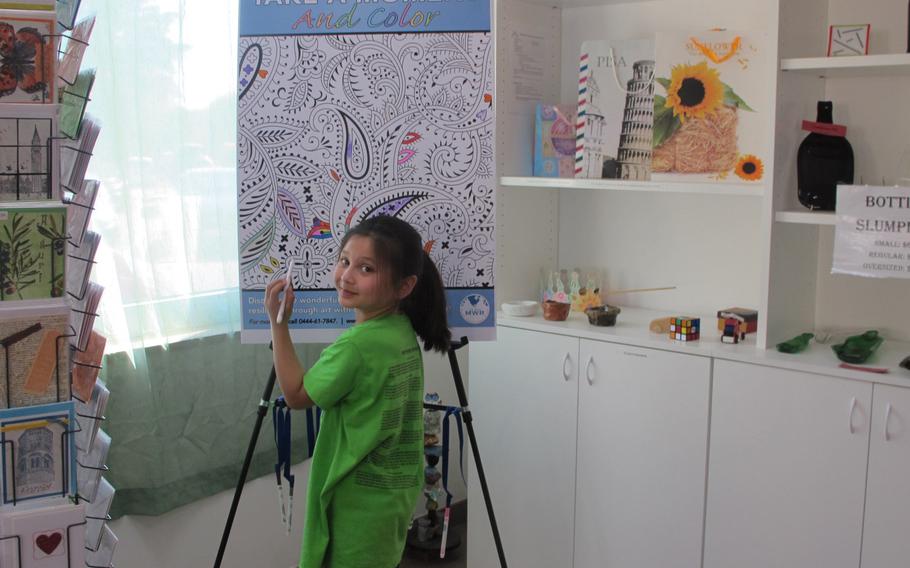 Jasmyne Holcombr takes a moment to color at the Vicenza Arts and Craft Center. The Vicenza center staff wants to put coloring boards and chalkboards in spaces such as lawyers' and doctors' waiting areas throughout the base to engage and relax people.