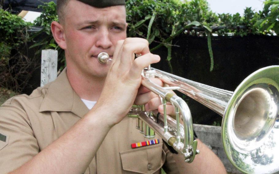 Lance Cpl. Nicholas Turner of the III Marine Expeditionary Force band plays taps during the 73rd annual memorial ceremony honoring famed war correspondent Ernie Pyle, in Okinawa, Japan, Sunday, April 23, 2018.