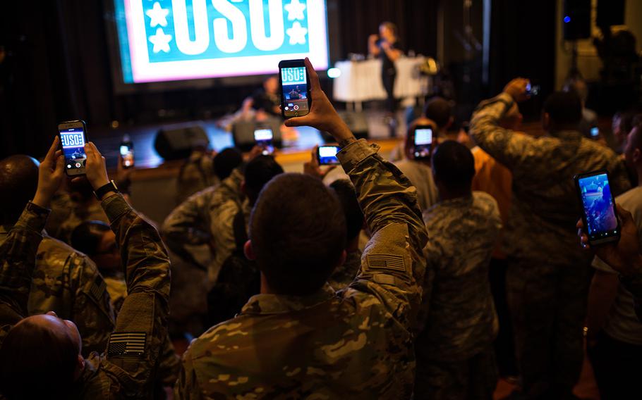 Servicemembers take photos and videos during a USO show at Osan Air Base, South Korea, Monday, April 23, 2018.