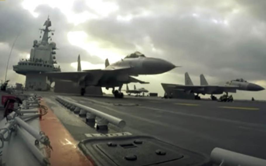 Fighter jets prepare to take off from the Chinese aircraft carrier Liaoning in this screenshot from a promotional video released last year by the communist state.