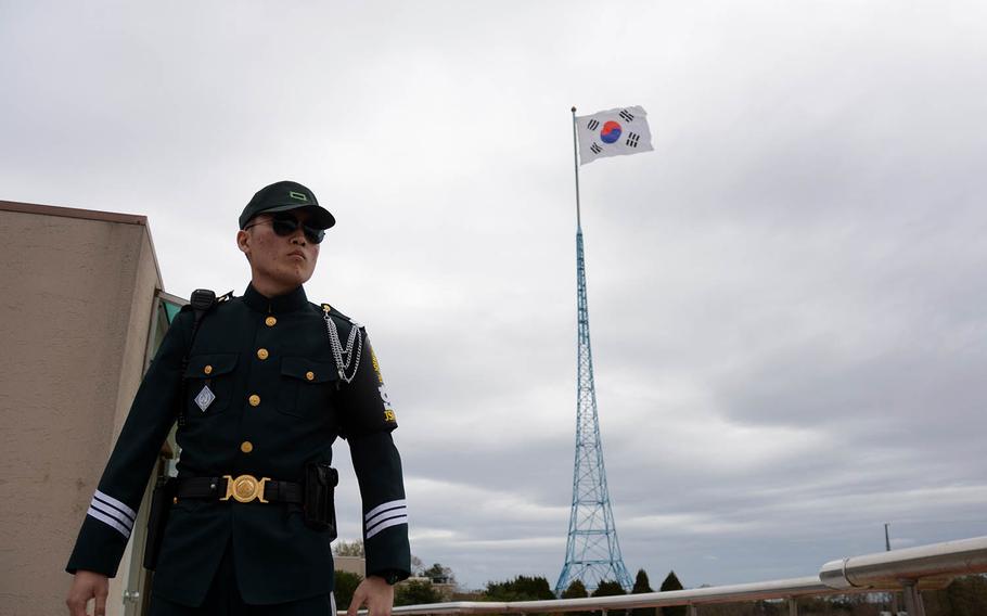 A member of the United Nations Command security force stands guard with the South Korean flag flying behind him in the village of Taesong-dong, Tuesday, April 24, 2018. It is the only place where civilians live in the Demilitarized Zone.