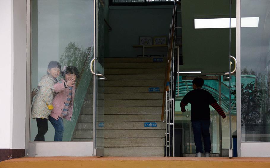 Children play in a doorway at the elementary school in the South Korean farming hamlet of Taesong-dong, which the military calls Freedom Village, Tuesday, April 24, 2018.