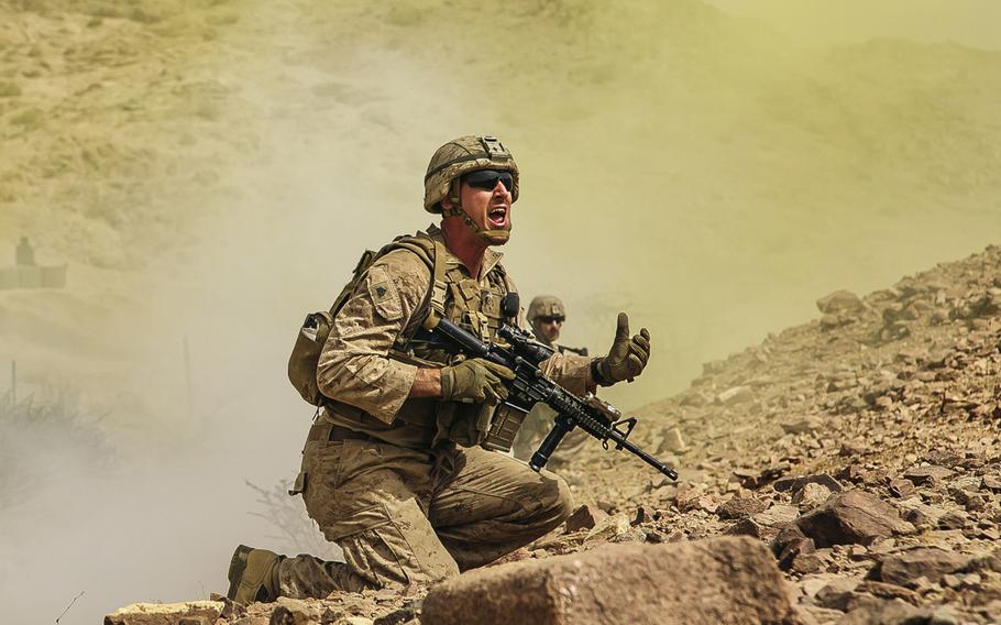U.S. Marine Corps Sgt. Sean O'Neil, a squad leader assigned to Fox Company, Battalion Landing Team, 2nd Battalion, 6th Marine Regiment, 26th Marine Expeditionary Unit, directs his squad's movement during live-fire training in Jordan as part of Eager Lion 2018, Saturday, April 21, 2018.