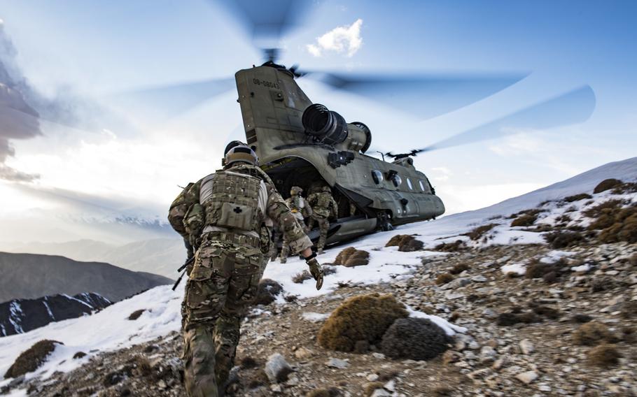 U.S. Air Force pararescuemen, assigned to the 83rd Expeditionary Rescue Squadron, work with members of  Army Task Force Brawler flying the CH-47F Chinook after the completion of a training exercise at Bagram Airfield, Afghanistan, March 14, 2018.