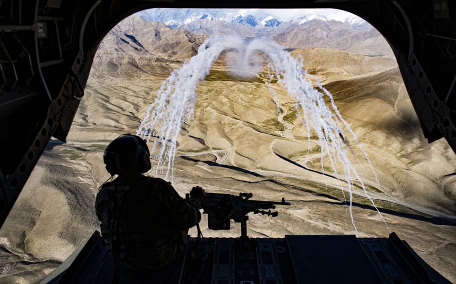 A U.S. Army crew chief aboard the CH-47F Chinook observe the successful test of threat countermeasures during a training flight in Afghanistan, March 14, 2018.