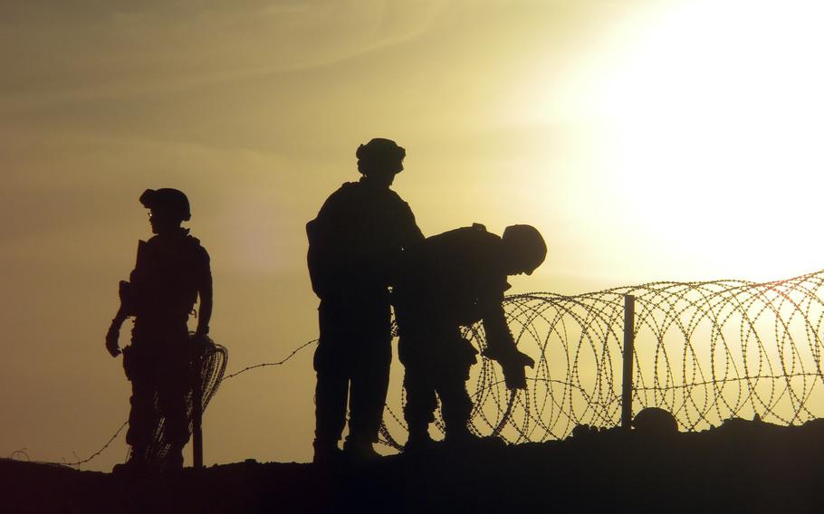 A Navy Seabee helps install concertina wire at an undisclosed area in this State Department photo from Monday, December 20, 2010.