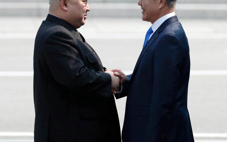 North Korean leader Kim Jong Un, left, greets South Korean President Moon Jae-in at the Joint Security Area of the Demilitarized Zone, Friday, April 27, 2018.