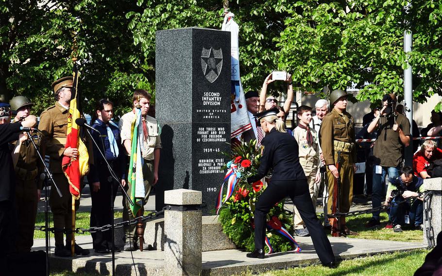 A Czech police officer lays flowers at one of the monuments to U.S. soldiers in the City of Pilsen, Czech Republic, Friday, May 4, 2018.