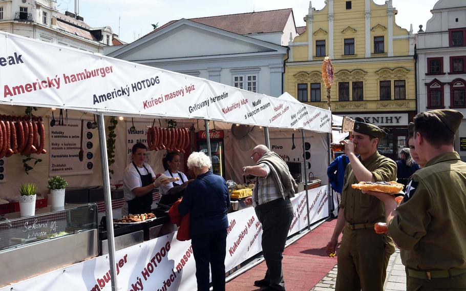 Czech re-enactors, dressed as World War II GIs, enjoy American-style food during the liberation festival in Pilsen, Czech Republic, Friday, May 4, 2018.