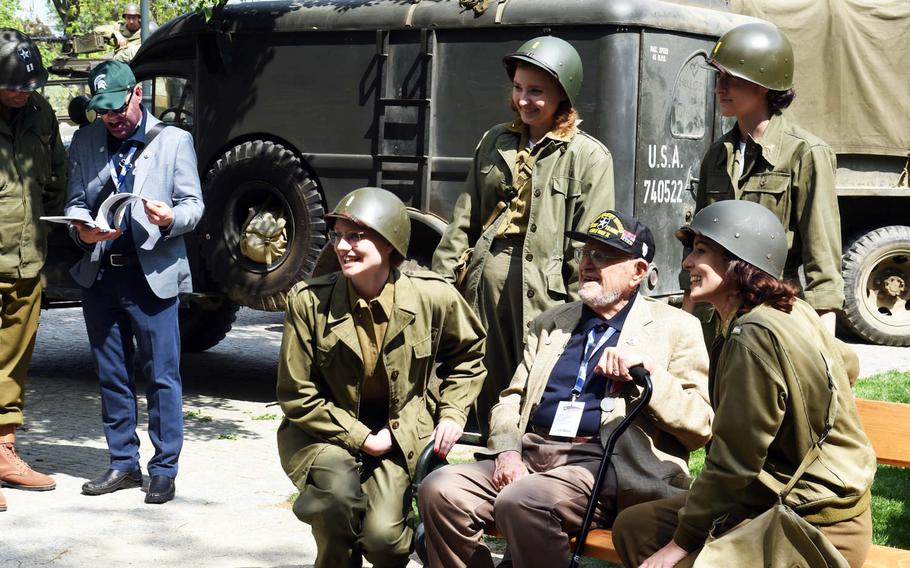 U.S. World War II veteran James Duncan poses with Czech re-enactors during the liberation festival in Pilsen, Czech Republic, Friday, May 4, 2018.