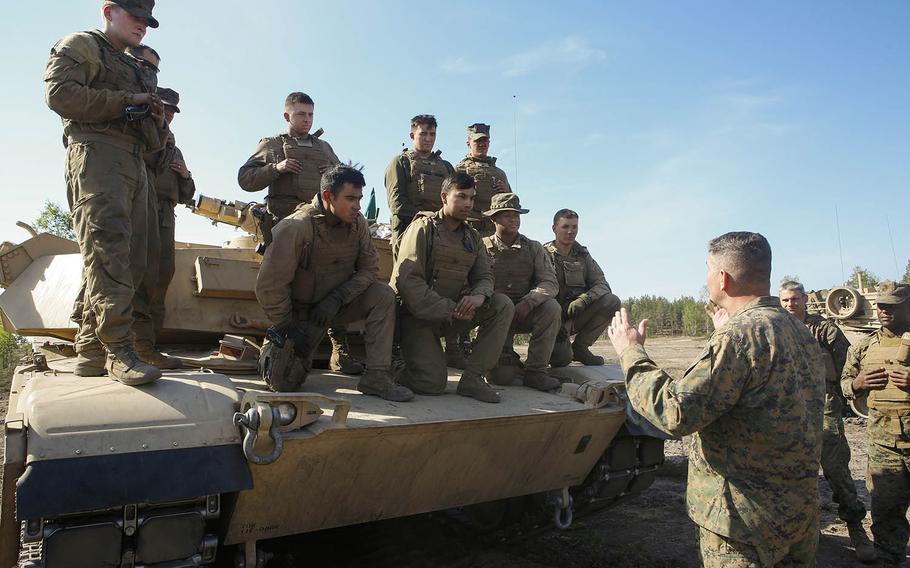 Col. John J. Carroll, the deputy commander of Marine Forces Europe and Africa, talks to Marines with 2nd Platoon, Company B., 4th Tanks from the state of Washington during Exercise Arrow 18 in Pohjankangas Training Area, Finland, May 15, 2018. 