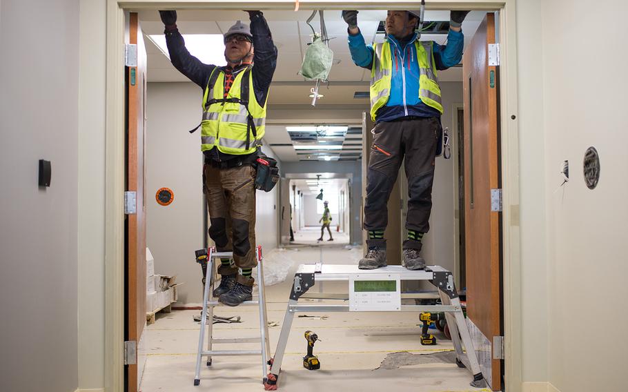 Workers build a doorframe at the hospital under construction at Camp Humphreys, South Korea, Wednesday, April 18, 2018.