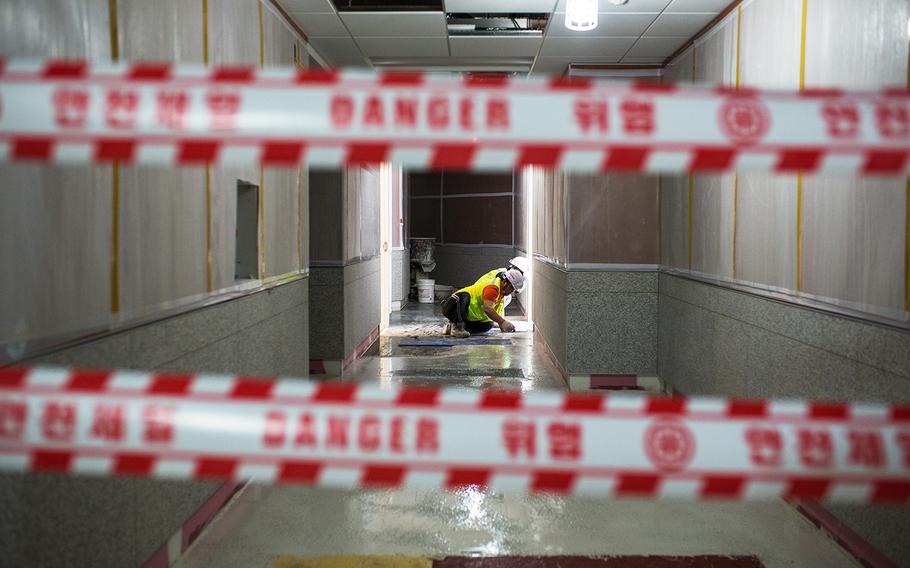South Korean workers finish a floor at a hospital under construction at Camp Humphreys, South Korea, Wednesday, April 18, 2018.