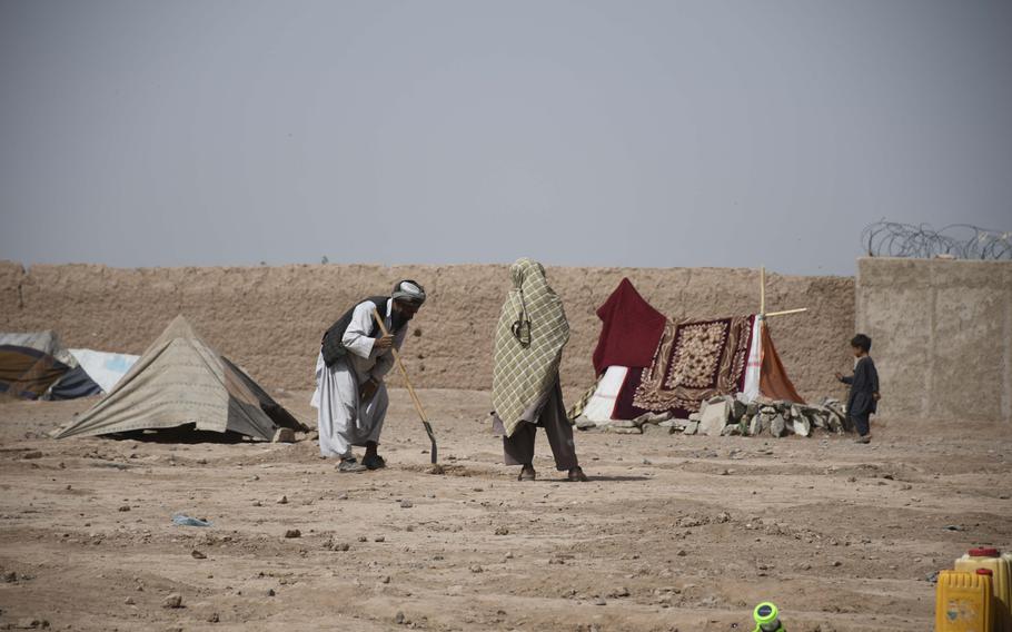 An Afghan man prepares his tent site June 2, 2018, in a camp for internally displaced people on the outskirts of Herat.