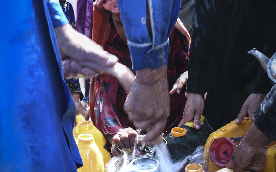 Afghan children draw water delivered by the city of Herat to the estimated 20,000 internally displaced people who have settled into camps on the outskirts of Herat due to drought and warfare.