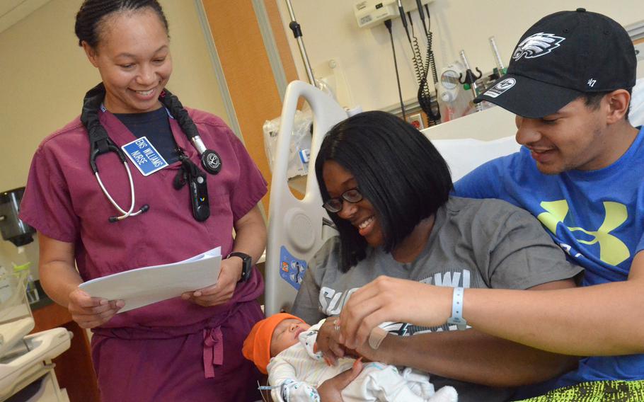 Ensign Rhonaka Williams, a nurse at Naval Hospital Jacksonville?s maternal infant unit, reviews discharge instructions with Machinist?s Mate 3rd Class Danesha Jones and Machinist?s Mate 3rd Class Tyreke Jones after the birth of their baby boy. The Navy announced a new parental leave plan on Thursday.