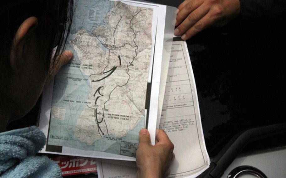 Kuentai-USA secretary general Yukari Akatsuka studies U.S. military maps and personnel files on missing servicemembers from World War II before taking to the Okinawa jungle May 9, 2018, in an attempt to find a missing U.S. Marine lost during the Battle of Okinawa.