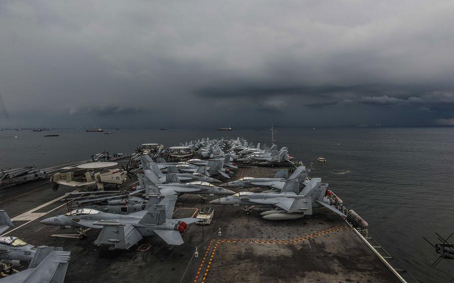 The USS Ronald Reagan sails along the coast of the Philippines in the Philippine Sea on its way to a port visit in Manila on Tuesday, June 26, 2018.