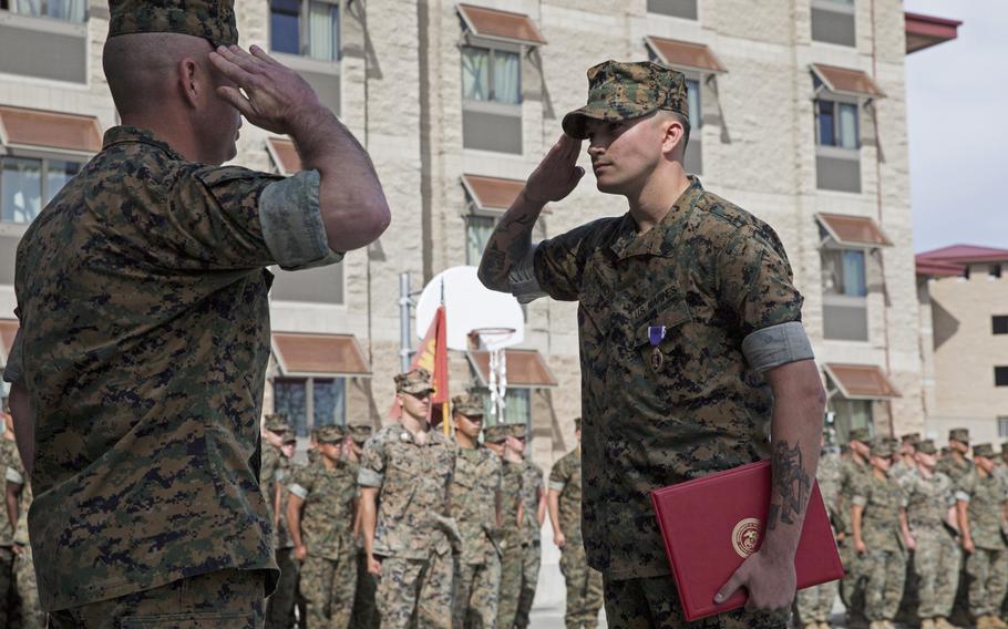 U.S. Marine Corps Sgt. Cameron T. Halkovich, right, a combat engineer with 1st Combat Engineer Battalion, 1st Marine Division, salutes Lt. Colonel Christopher Haar, the commanding officer of 1st CEB, at Marine Corps Base Camp Pendleton, Calif., April 24, 2018. Halkovich was awarded the Purple Heart for wounds received in action on Feb. 17, 2018, in support of operation Inherent Resolve.