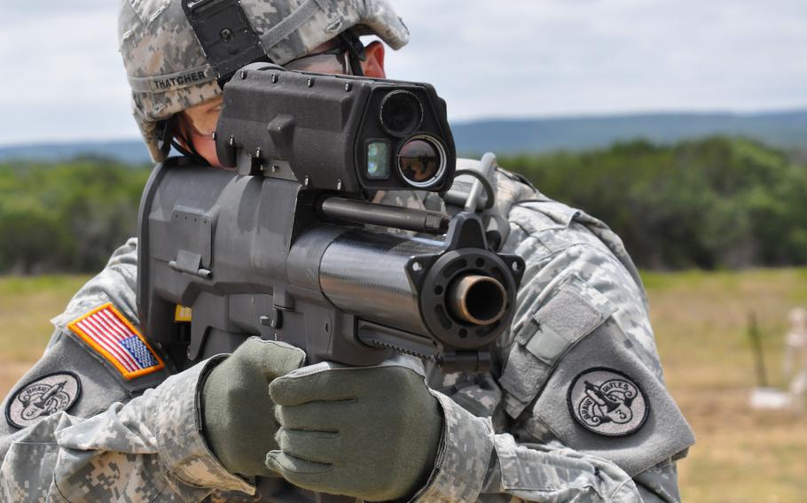 A soldier demonstrates the  XM25 Counter Defilade Targeting Engagement System at Aberdeen Test Center, Md. in 2009.