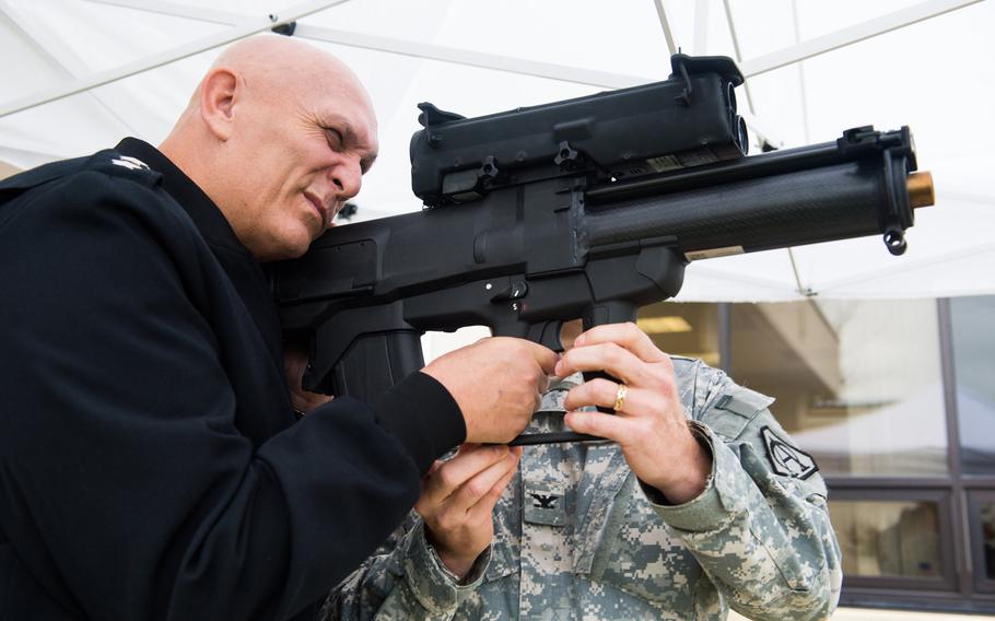 Then-U.S. Army Chief of Staff Gen. Ray Odierno looks through the  sight of an XM25 Counter Defilade Target Engagement System during his visit to Fort Belvoir, VA, in 2013.