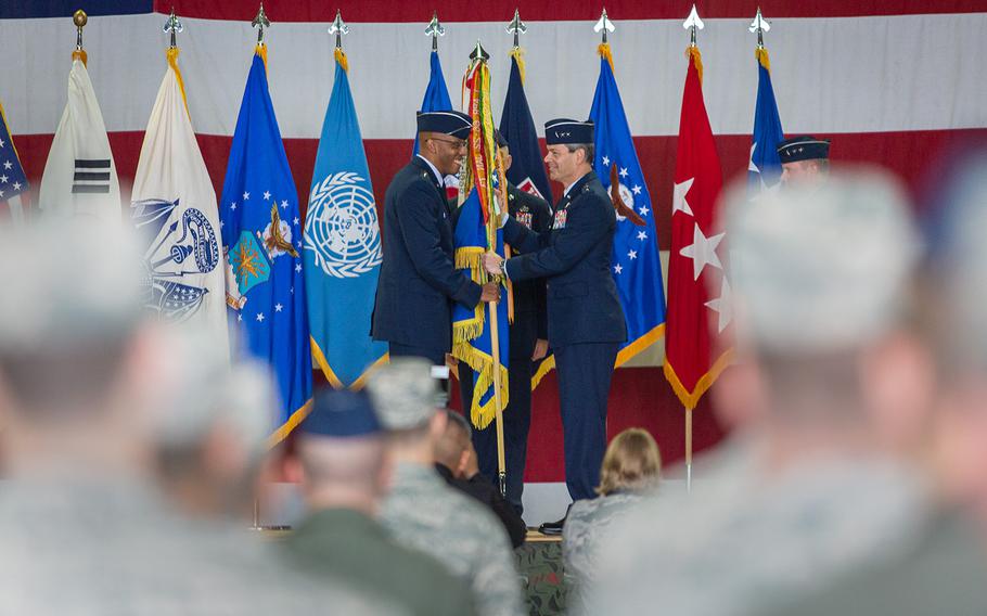 Pacific Air Forces Commander Gen. Charles Brown Jr., left, passes the 7th Air Force colors to Lt. Gen. Kenneth Wilsbach at Osan Air Base, South Korea, Monday, Aug. 27, 2018.