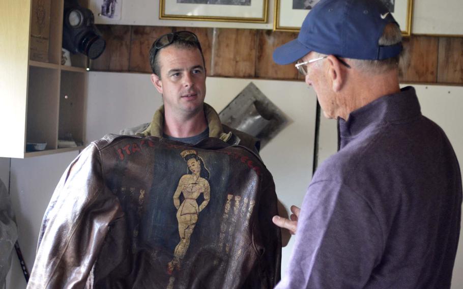 Andy Cox, a British farmer and part-time metal-detecting enthusiast , shows a bomber jacket from his personal World War II museum to American Ken Spatz at his home in Gosfield, England, Friday, Aug. 31, 2018. Ten years ago, Cox found a high school graduation ring belonging to Spatz's father and is now giving him the ring.

William Howard/Stars and Stripes