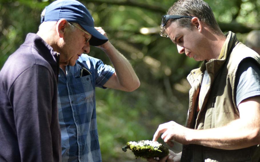 British farmer Andy Cox, right, shows some of the wreckage from a B-17 named Smashing Thru to Ken Spatz at the bomber's crash site in Ridgewell, England, Friday, Aug.31, 2018.

William Howard/Stars and Stripes