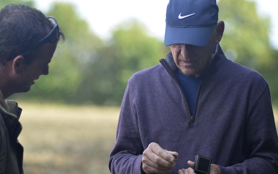 Ken Spatz sees his father's 1941 high school graduation ring near the site where he died in a World War II plane crash in Ridgewell, England, Friday, Aug. 31, 2018. "Just imagining that B-17 coming in here and flipping over is too big for me to talk about," Spatz said.
 
