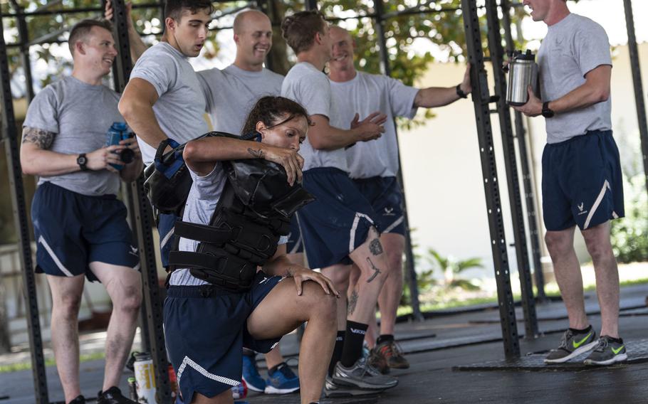 Staff Sgt. Ashley Banta, 48th Civil Engineer Squadron, Royal Air Force Lakenheath, England, lifts a 50-pound sandbag over her shoulder while wearing a 30-pound vest during the beta test of the Explosive Ordnance Disposal Tier 2 fitness test prototype, Sept. 10, 2018, at Eglin Air Force Base, Fla.